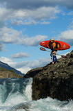 Whitewater kayaker scouting rapids Baker River, Chile