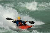 Whitewater kayaker bracing while surfing Baker River, Patagonia,