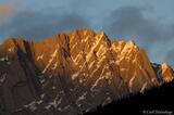 Sunset lights up the high peaks and crags of the Canadian Rockie