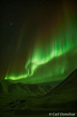 Bright Green Aurora Curtains Above Snowy Valley