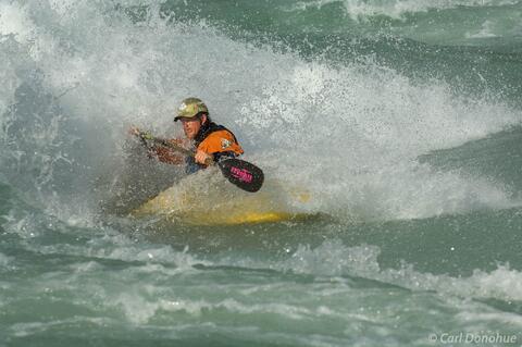 Whitewater kayaker, Baker River, surfing a wave, Patagonia