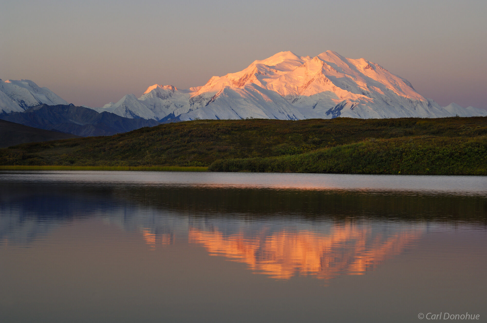 "Denali", officially known as Mt. McKinley, the highest peak in North America, stands above the Alaska Range, a small kettle...