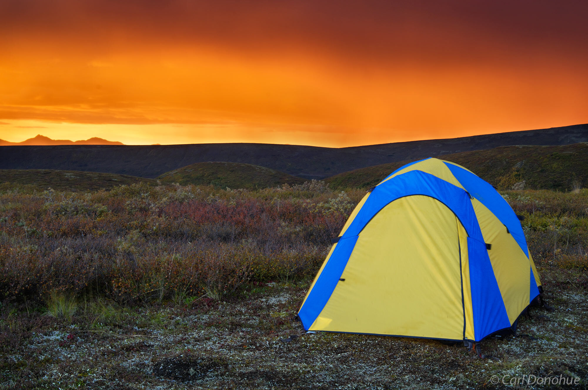 A backpacker's tentsite on the tundra is a nice spot to view the sunset, Denali National Park, Alaska.