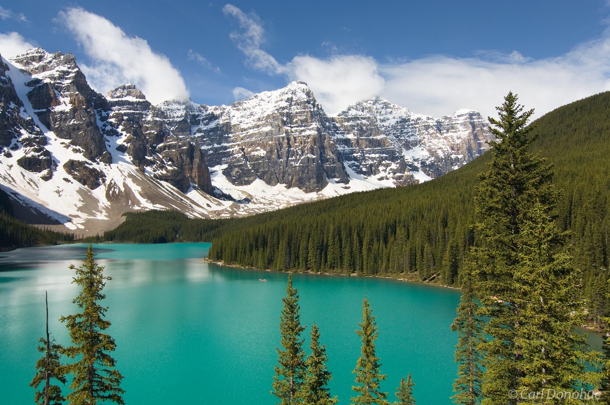 Moraine Lake, reflections and pine forest, Canadian Rockies, Banff National Park, Alberta, Canada.