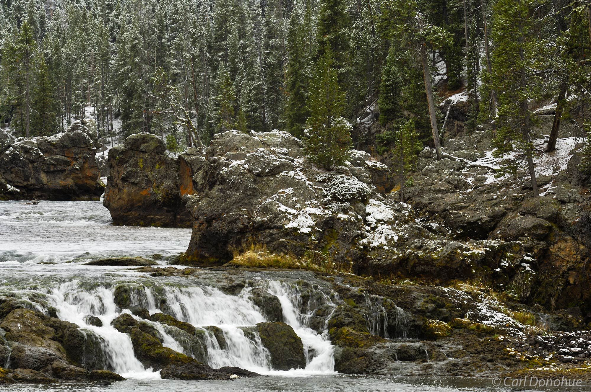 Fresh snow at the Upper Falls in Yellowstone National Park's canyon, Wyoming.