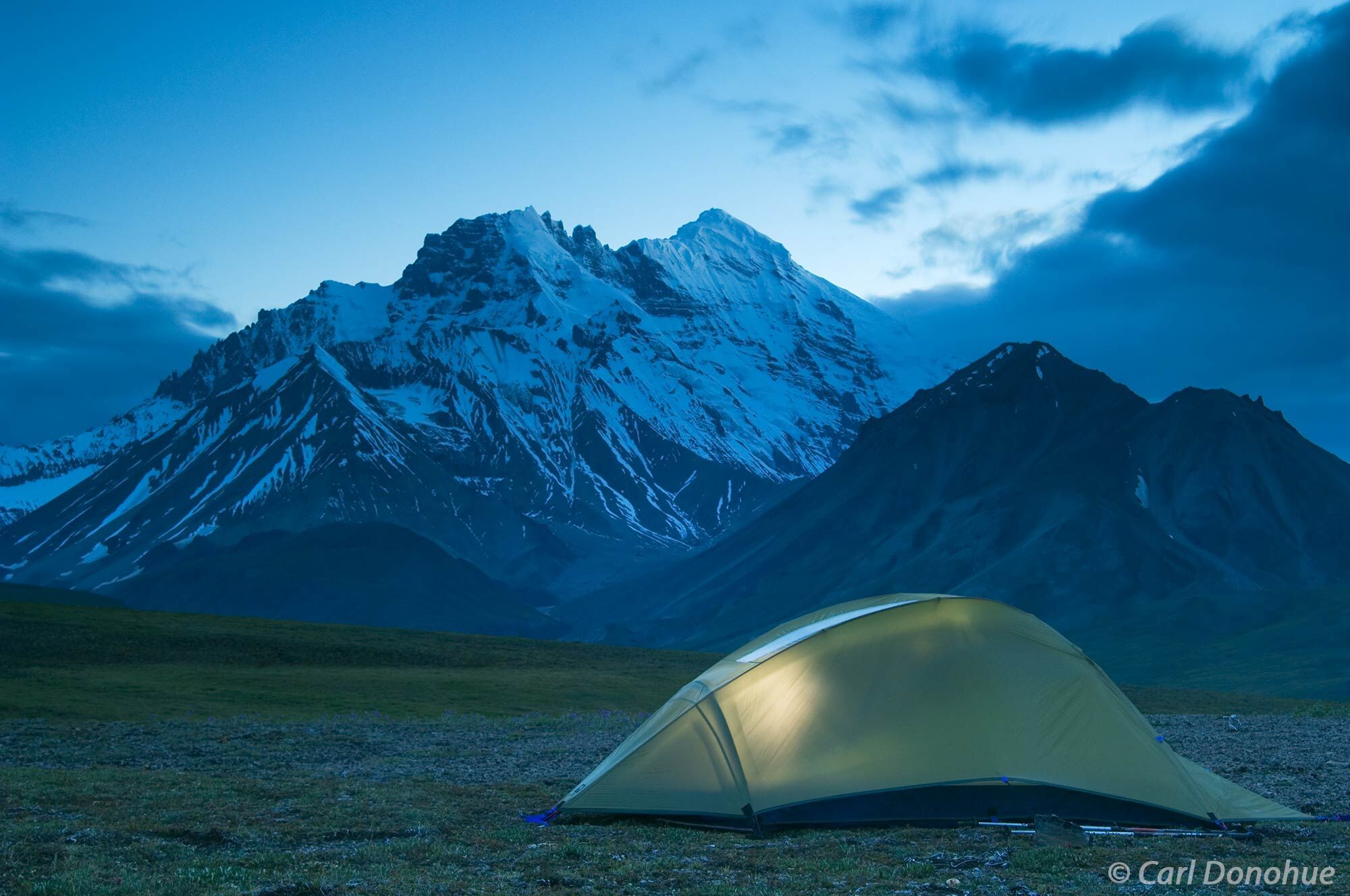 Camping on the Sanford Plateau after dark, with a view of Mt Drum. Wrangell-St. Elias National Park, Alaska.