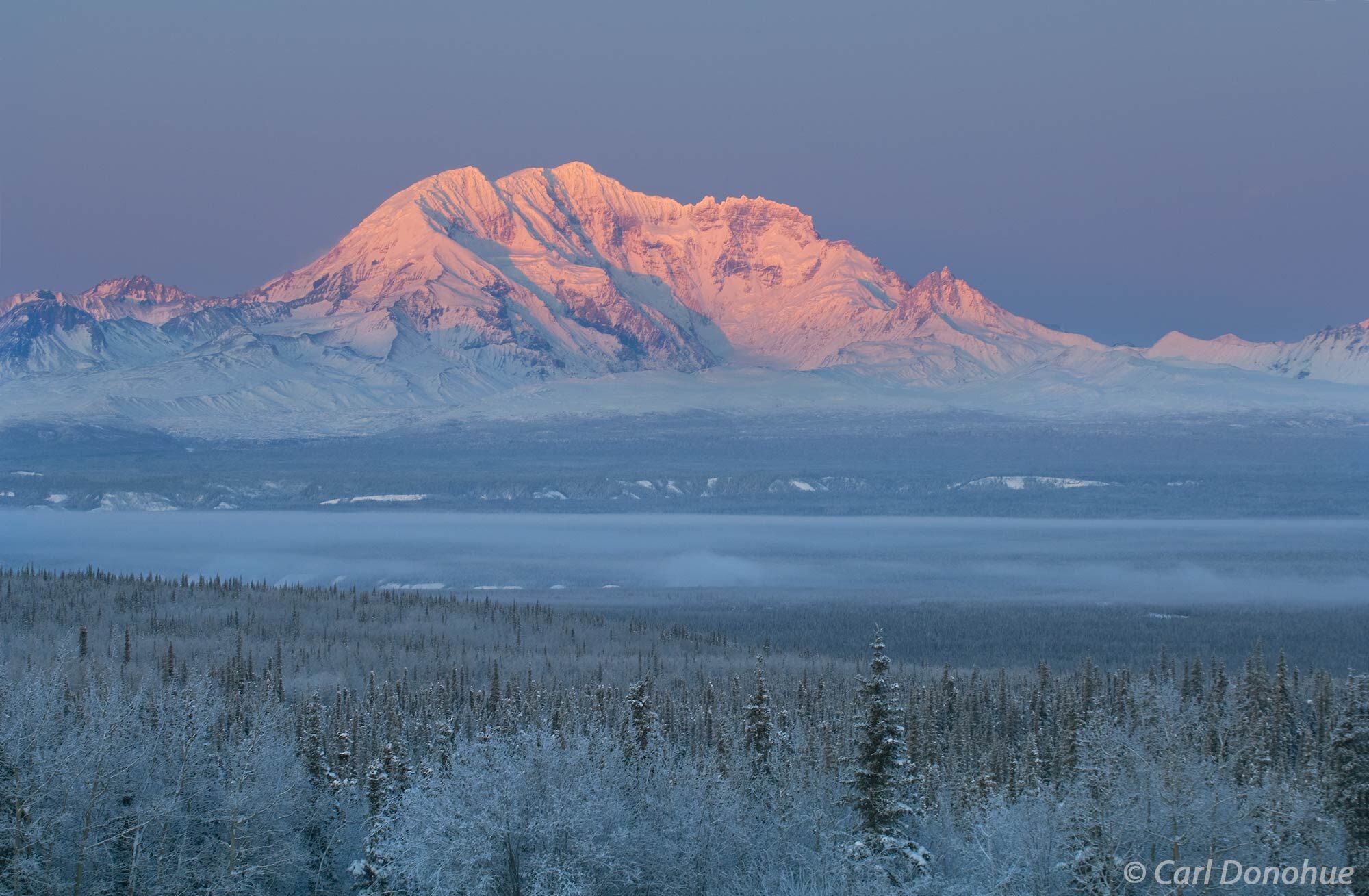 Winter alpenglow at sunset on Mount Drum. Photo shows the Copper River Basin, Wrangell-St. Elias National Park and Preserve...