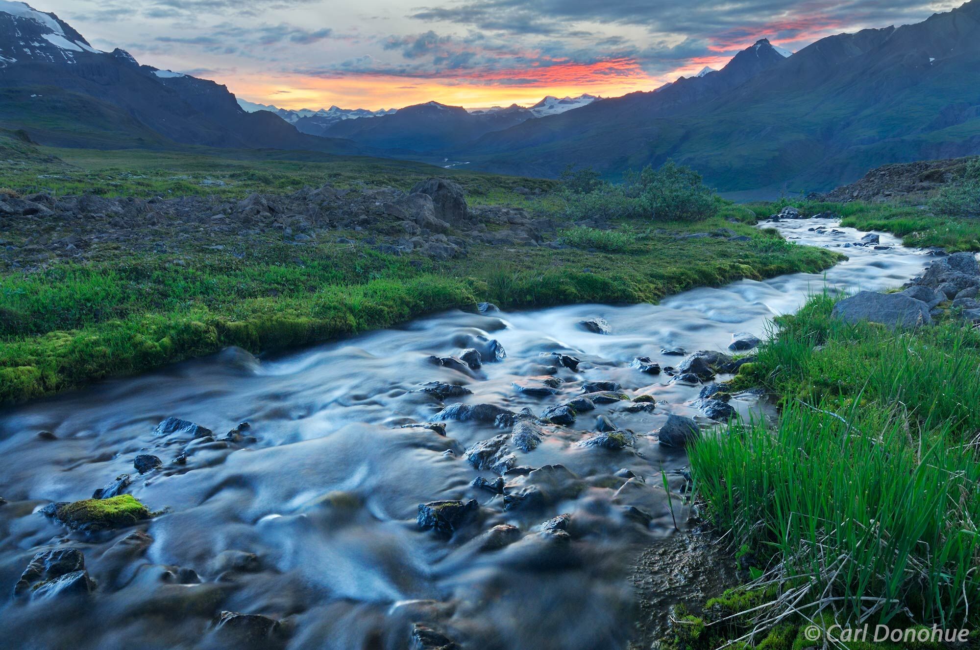 Sunset and a reflection in a stream, over Skolai Pass and the Wrangell Mountains, Wrangell-St. Elias National Park and Preserve...