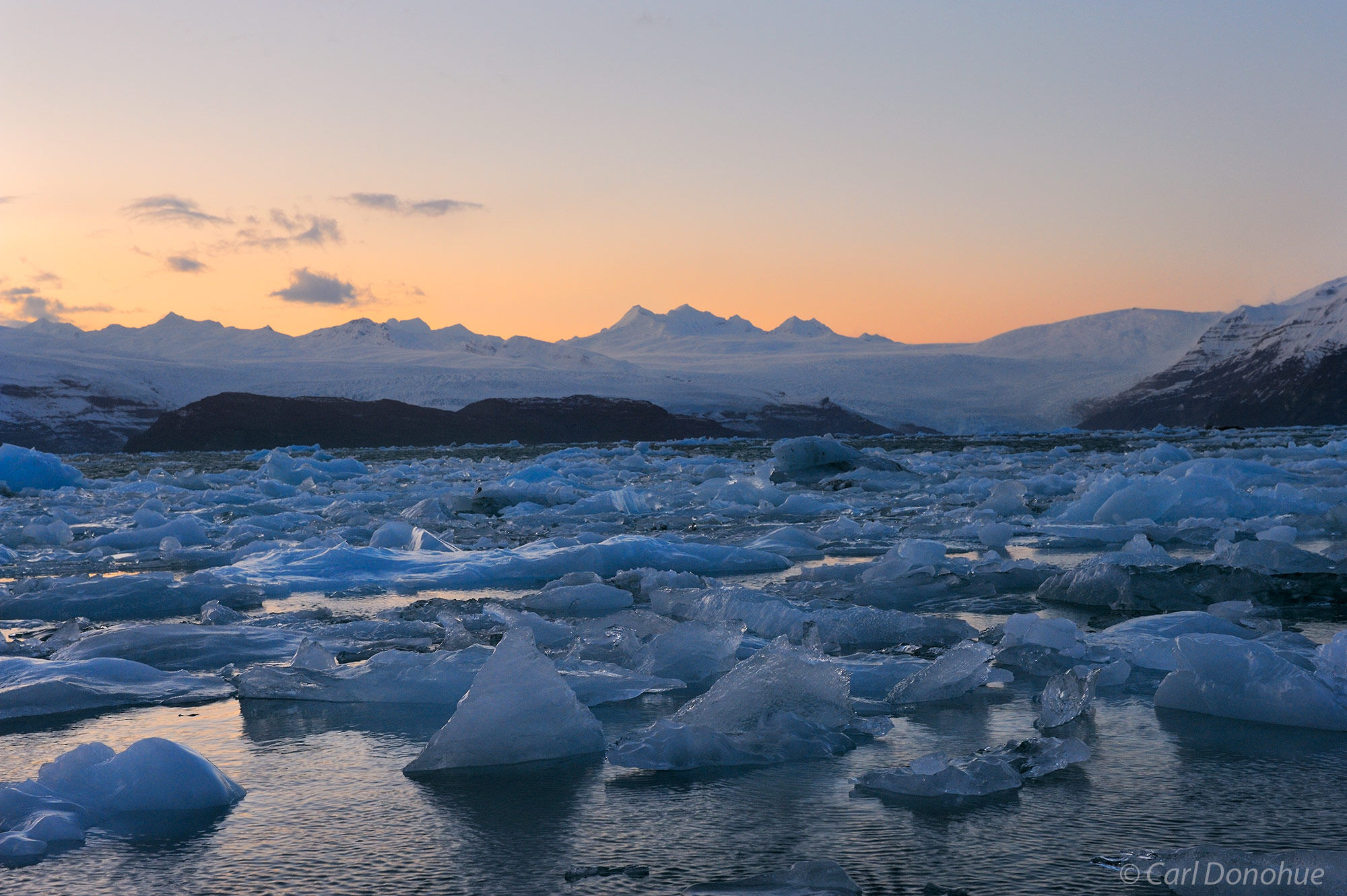 Icebergs on the shore at Icy Bay, the Guyot Hills in the background, and the last light of the day, after sunset. Icy Bay, Wrangell...