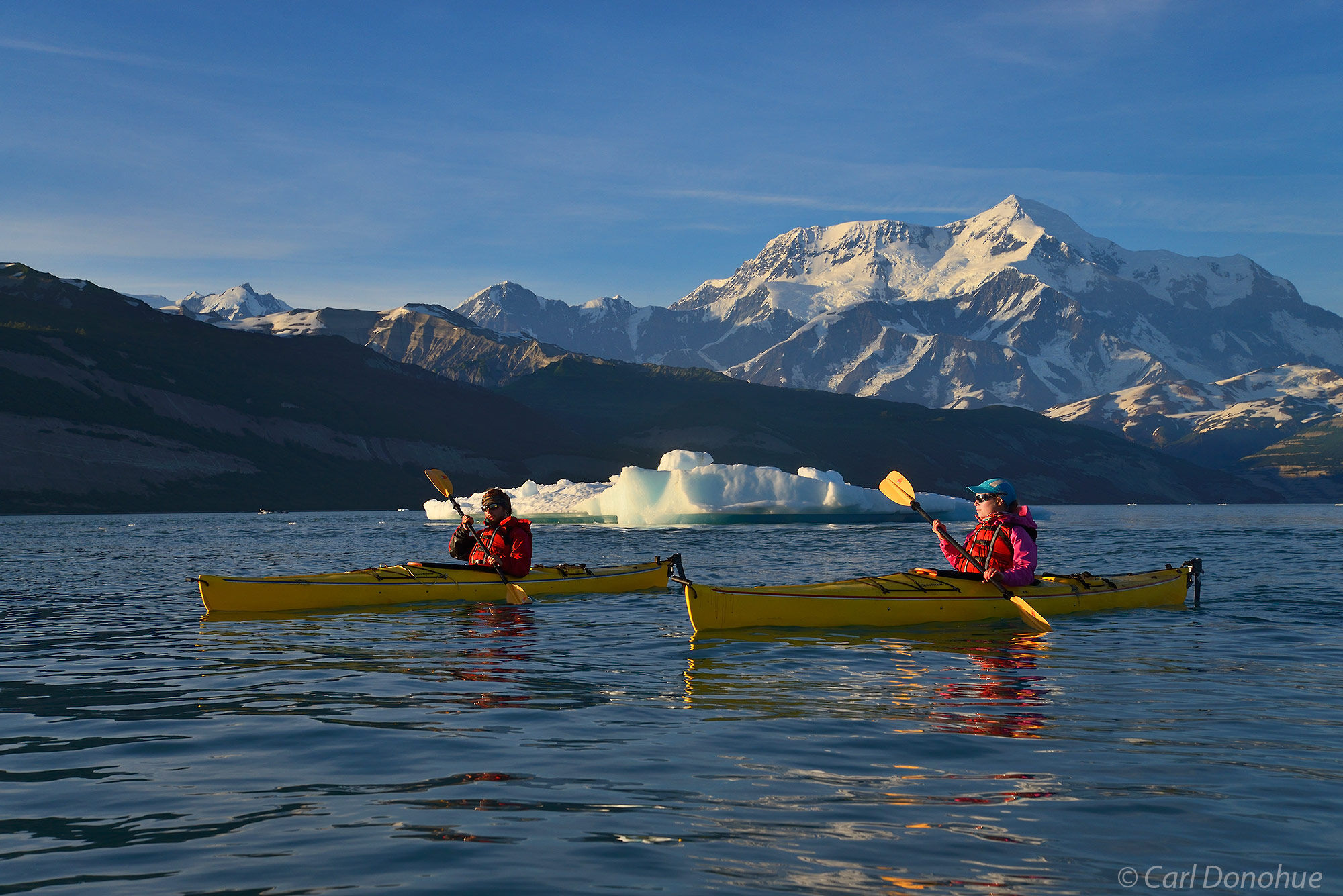 A couple sea kayaking in Icy Bay, Wrangell - St. Elias National Park and Preserve, Alaska.