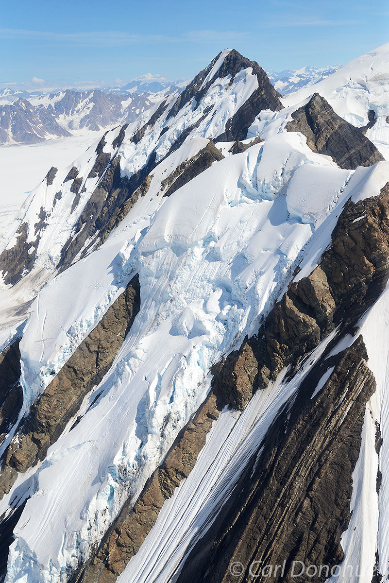 Unnamed peaks abound in the St. Elias Mountain Range. An aerial photo of ice and snow, glaciers and crevasses on an unnamed peak...