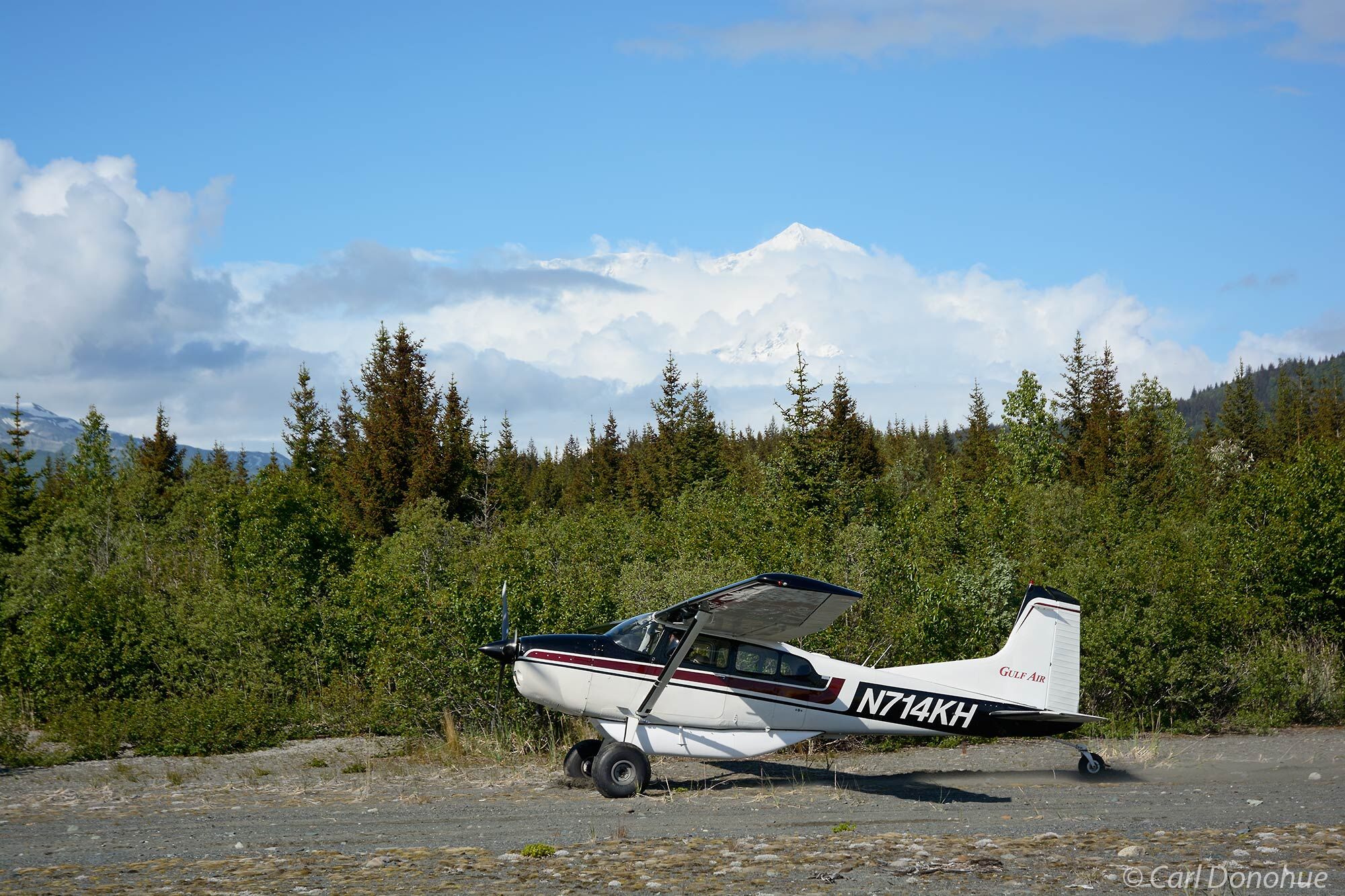 Alaska bush plane on sandbar runway at Icy Bay, Kageet Point, with Mt. St. Elias in the background, Wrangell - St. Elias  National...