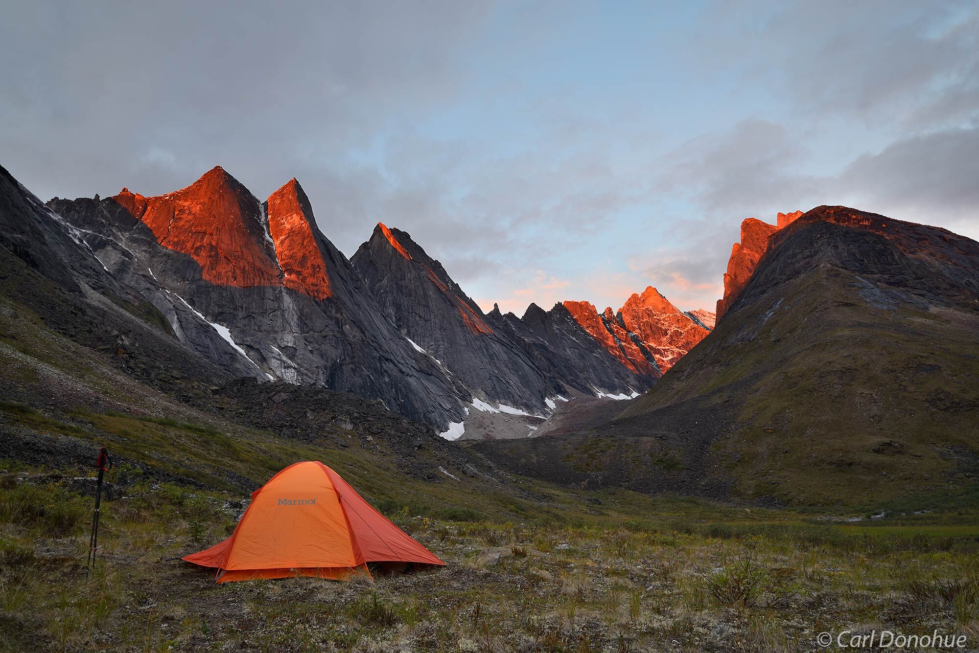 Backcountry campsite or tents beneath the mountain peaks known as the Maidens, Arrigetch Peaks,  sunset in Gates of the Arctic...