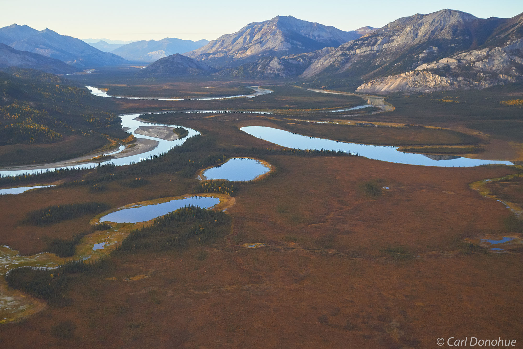 Aerial photo of fall colors and kettle ponds and meandering rivers of the Brooks Range, Gates of the Arctic National Park and...