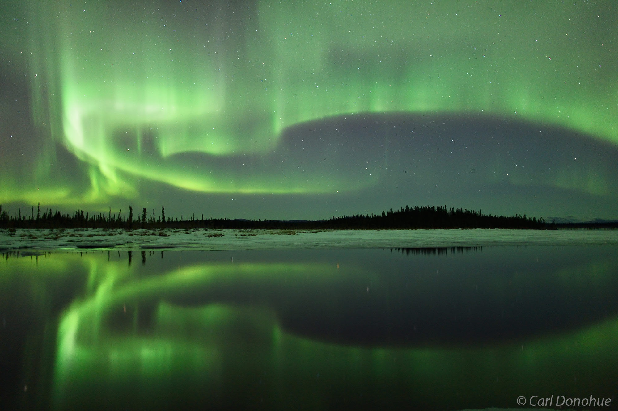 A massive Aurora borealis photo and a nice reflection to go with the glowing sky in interior Alaska. Aurora borealis, or northern...