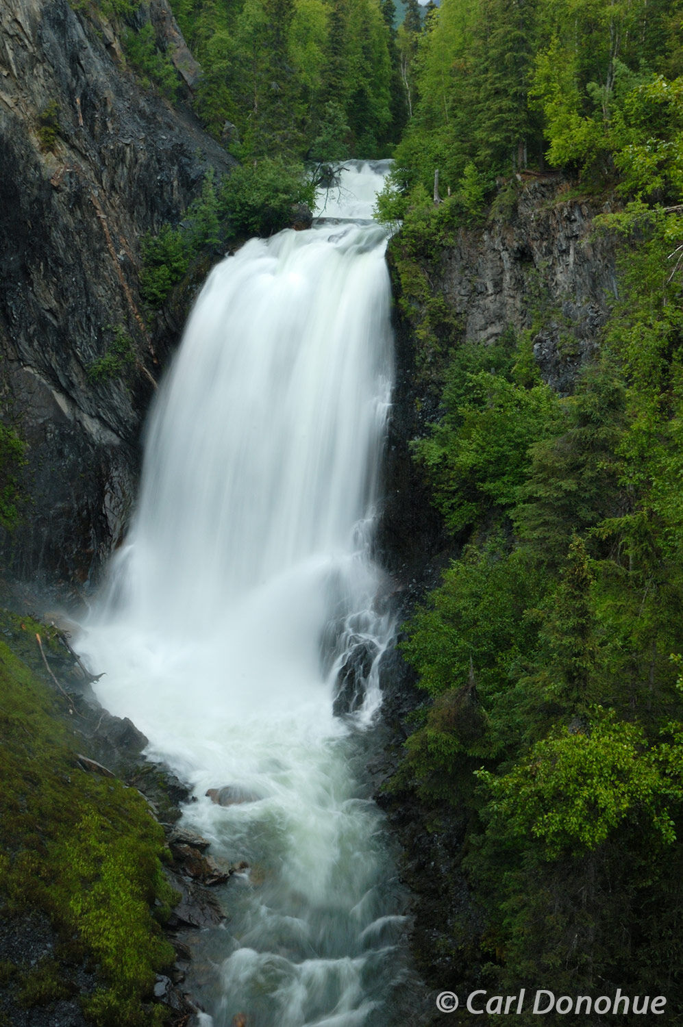 Thunderous waterfalls on Juneau Creek, Juneau Falls, crash into this steep narrow gorge in the Chugach National Forest.  Popular...