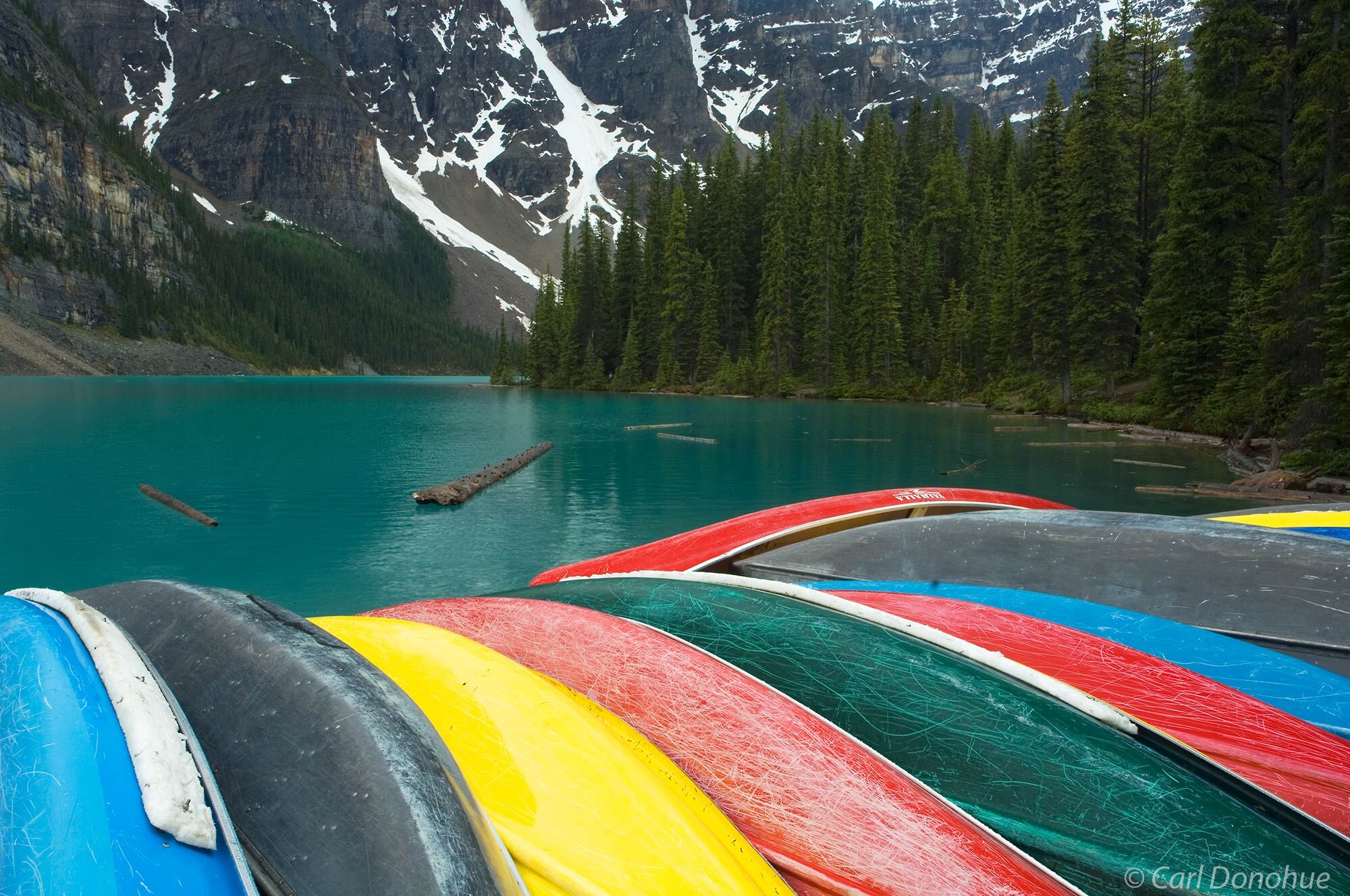 A colorful array of canoes lined up on the boat deck at Moraine Lake, Banff National Park, Alberta, Canada.