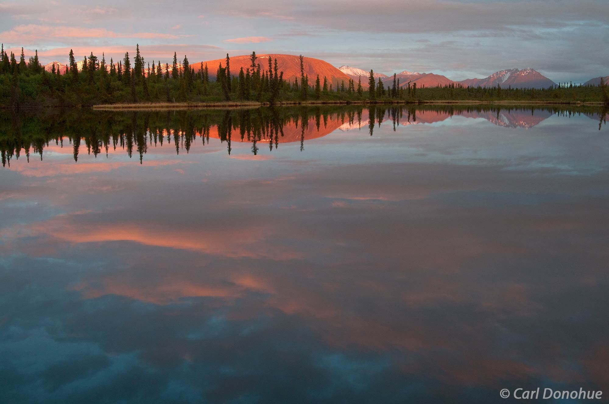 Rock lake reflections of Sugar Loaf mountain, sunset, Wrangell-St. Elias National Park and Preserve, Alaska.
