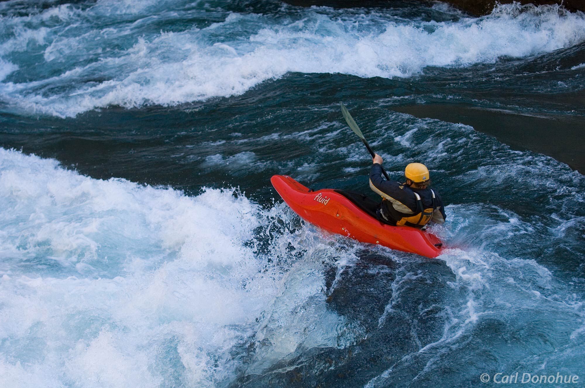A Whitewater kayaker boofs off a pourover in Entrada, a Class IV rapid in Hell's Canyon or Infierno Canyon, on the Futaleufu...