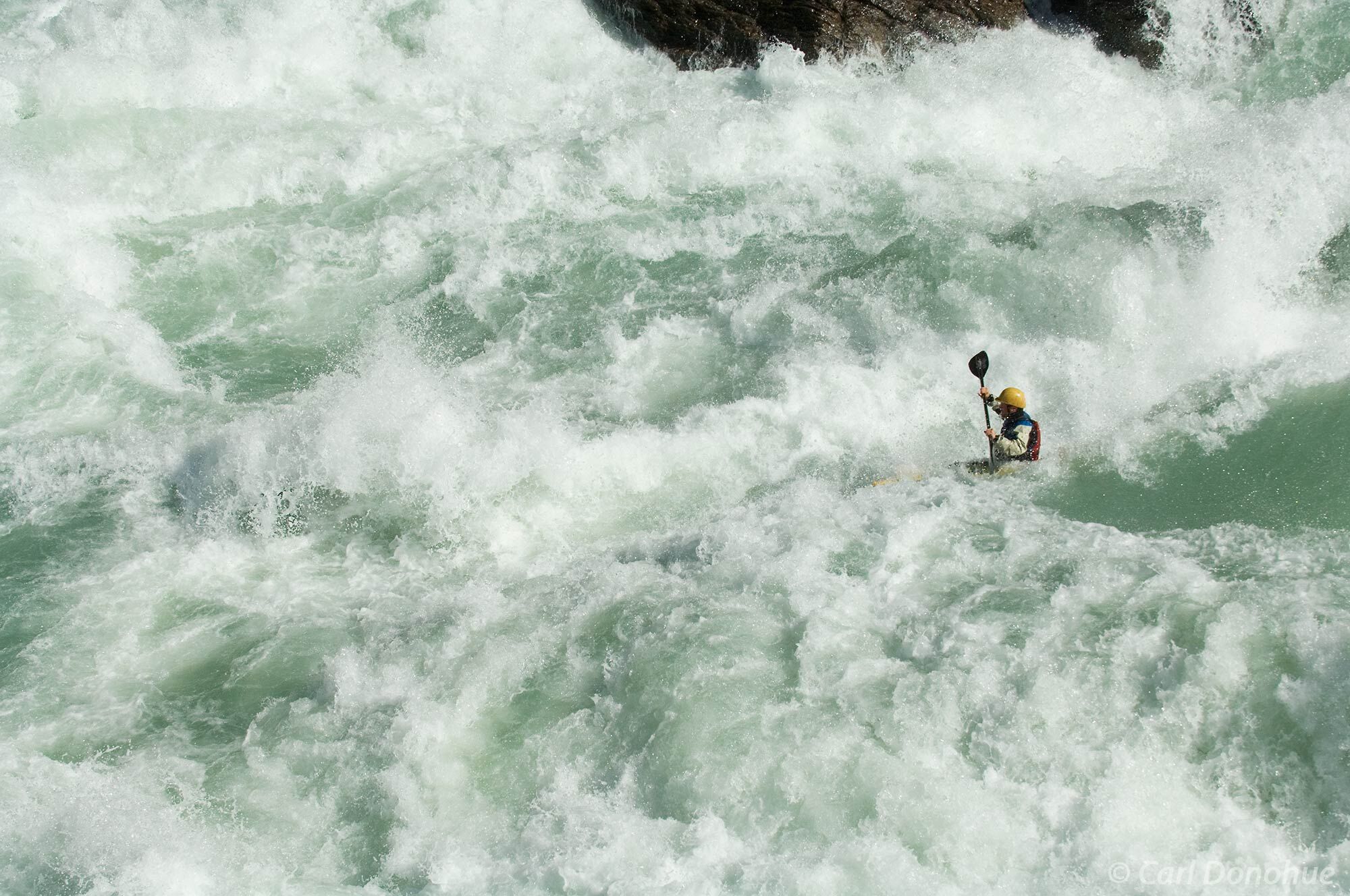 Whitewater kayaking on the Baker River. Class whitewater kayaking. This huge river dwarfs a kayak in this narrow canyon. Whitewater...