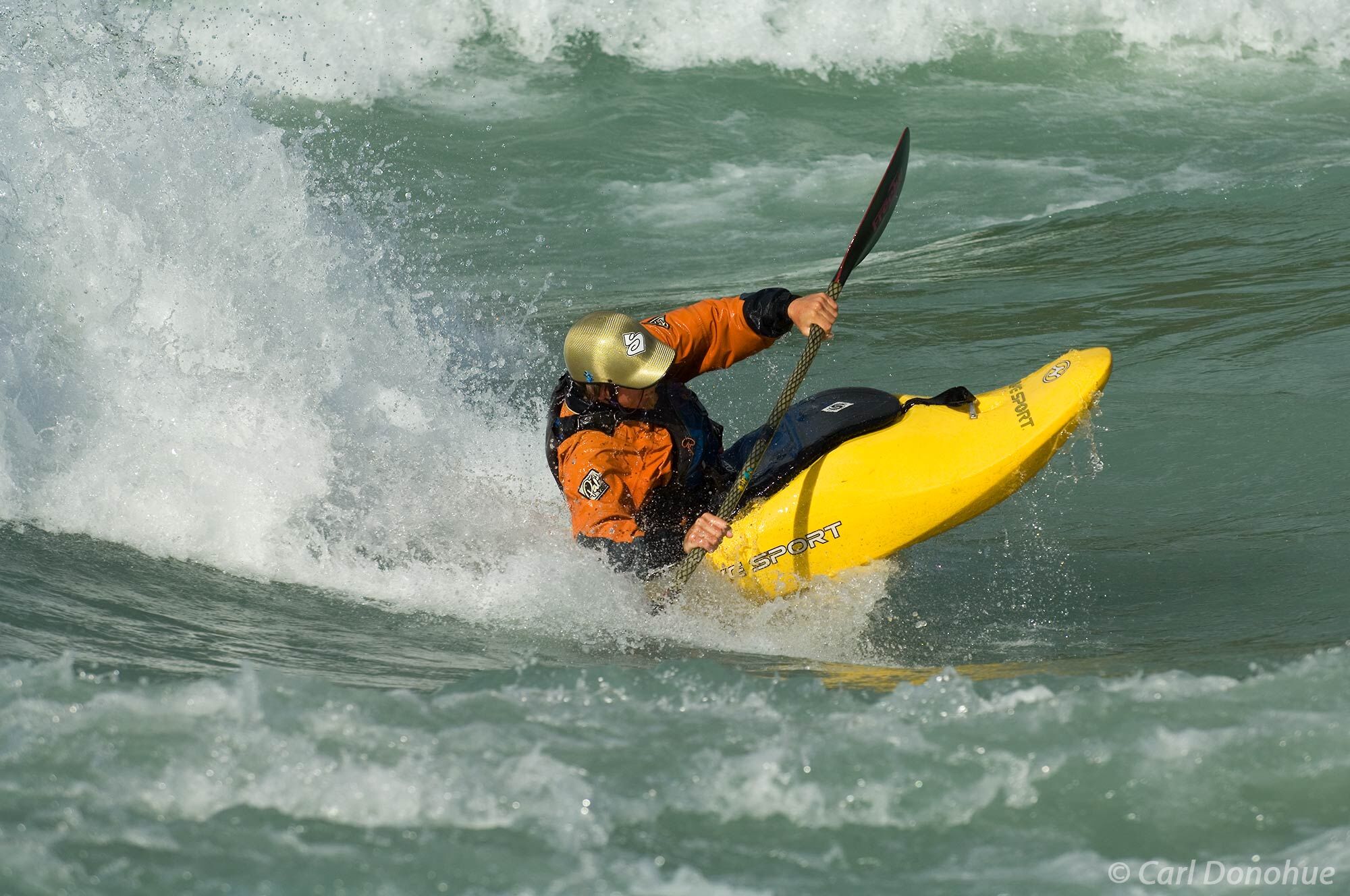 Whitewater kayaking on the Baker River. A standing wave provides Santiago Ibanez, a Peruvian kayaker, with endless opportunity...