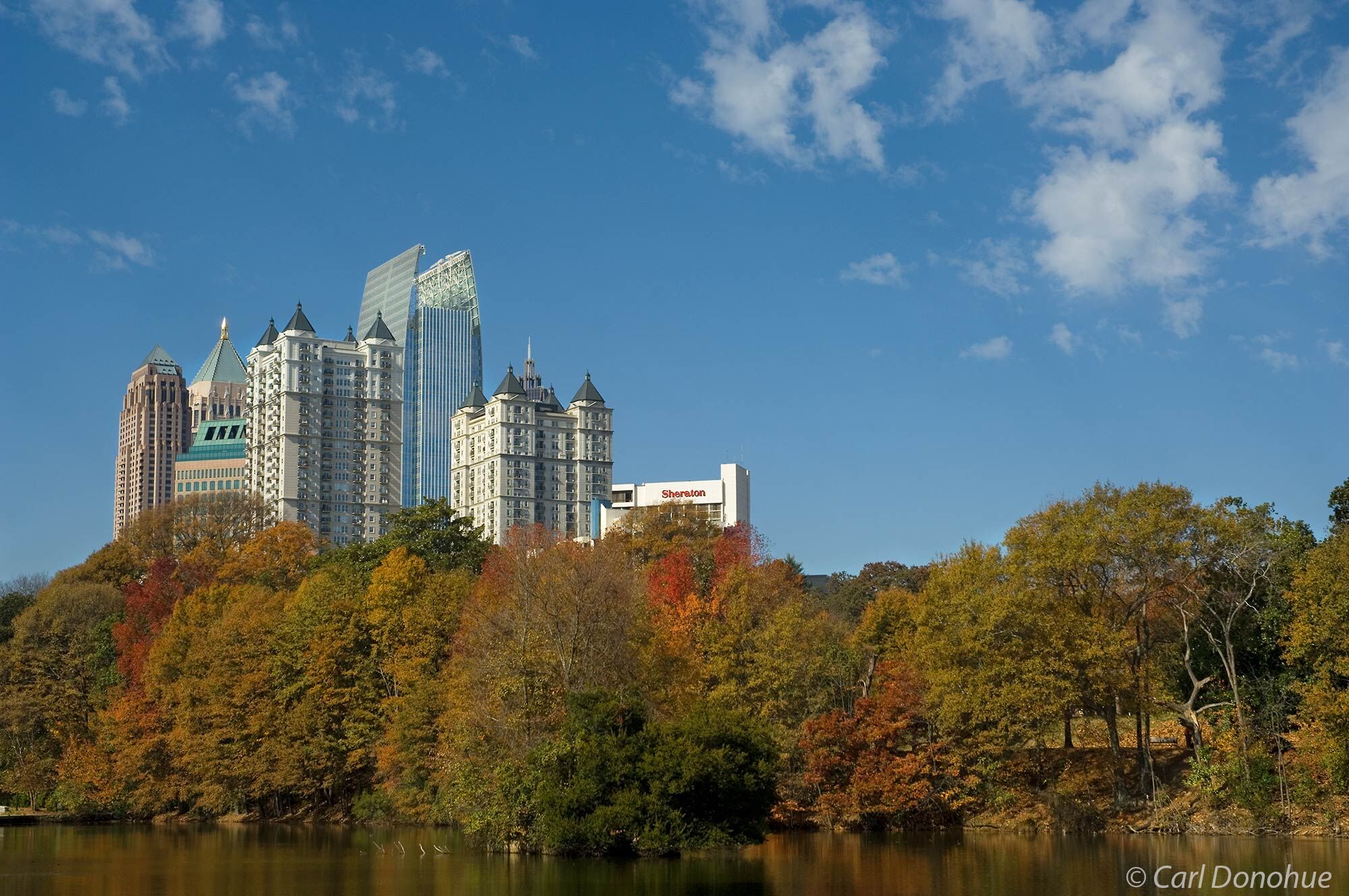 Midtown Atlanta skyline, in autumn, fall colors n the trees from Piedmont Park. Atlanta, Georgia.