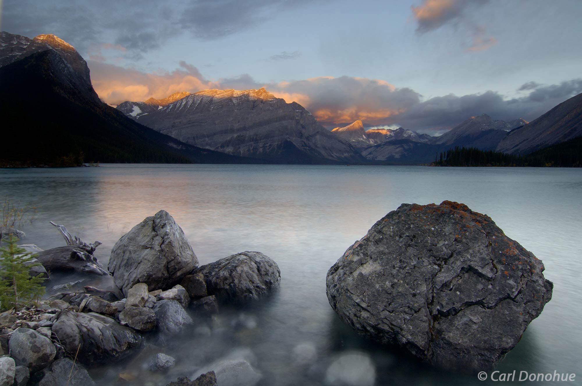 Dawn over Upper Kananaskis Lake. The first light of the day touches the highest peaks of the Canadian Rockies in Kananaskis Country...