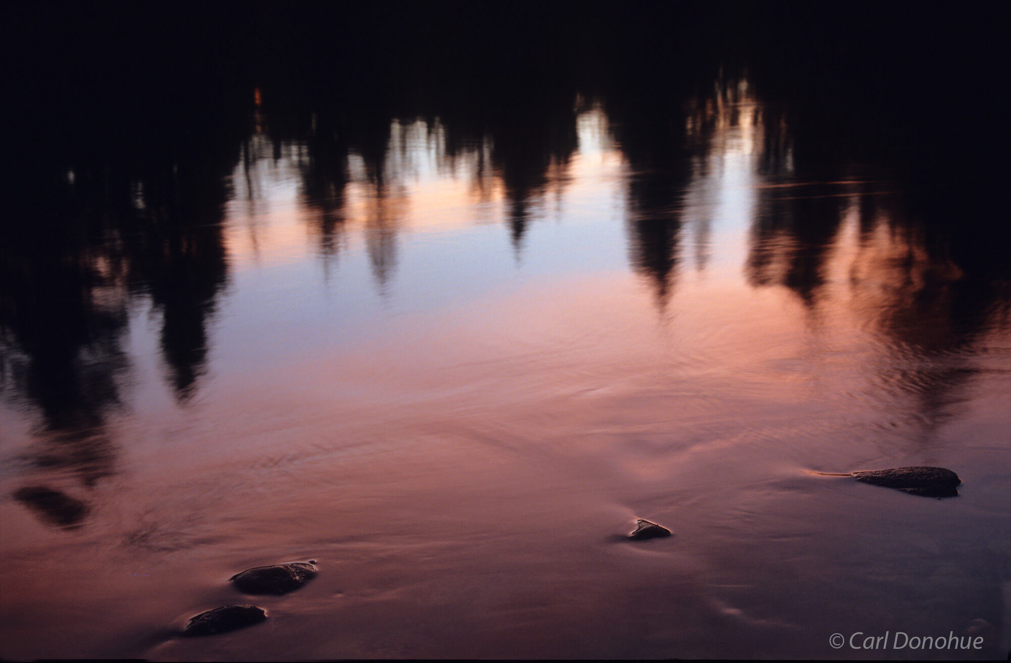 Abstract photo, reflections in Bowman Lake, sunset, Livingston Range, Glacier National Park, Montana.